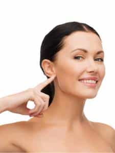 young calm woman pointing to her ear picture id524778847