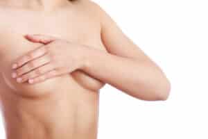A woman covering her breasts with her arm