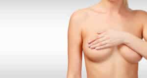 Woman covering her nipples with her arm