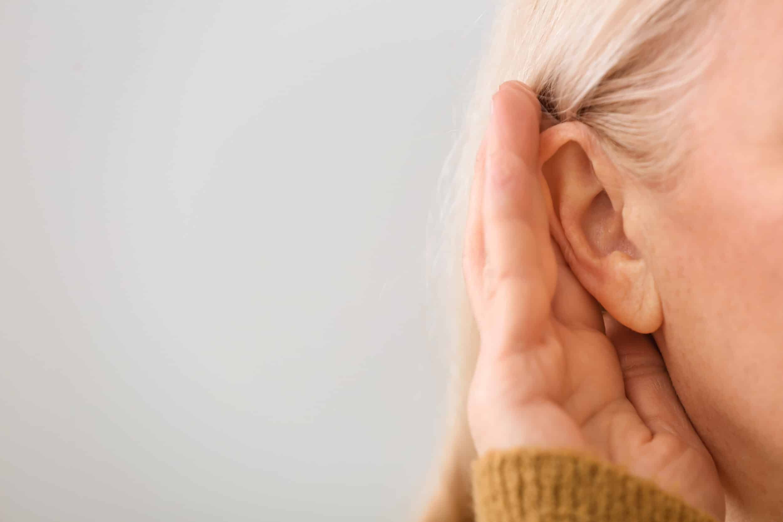 Woman cupping her ear