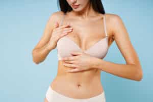 cWoman posing in a beige bra after a breast lift in Lone Tree, CO