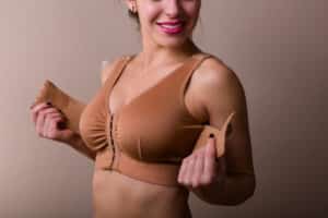 Woman wearing a compression garment after plastic surgery